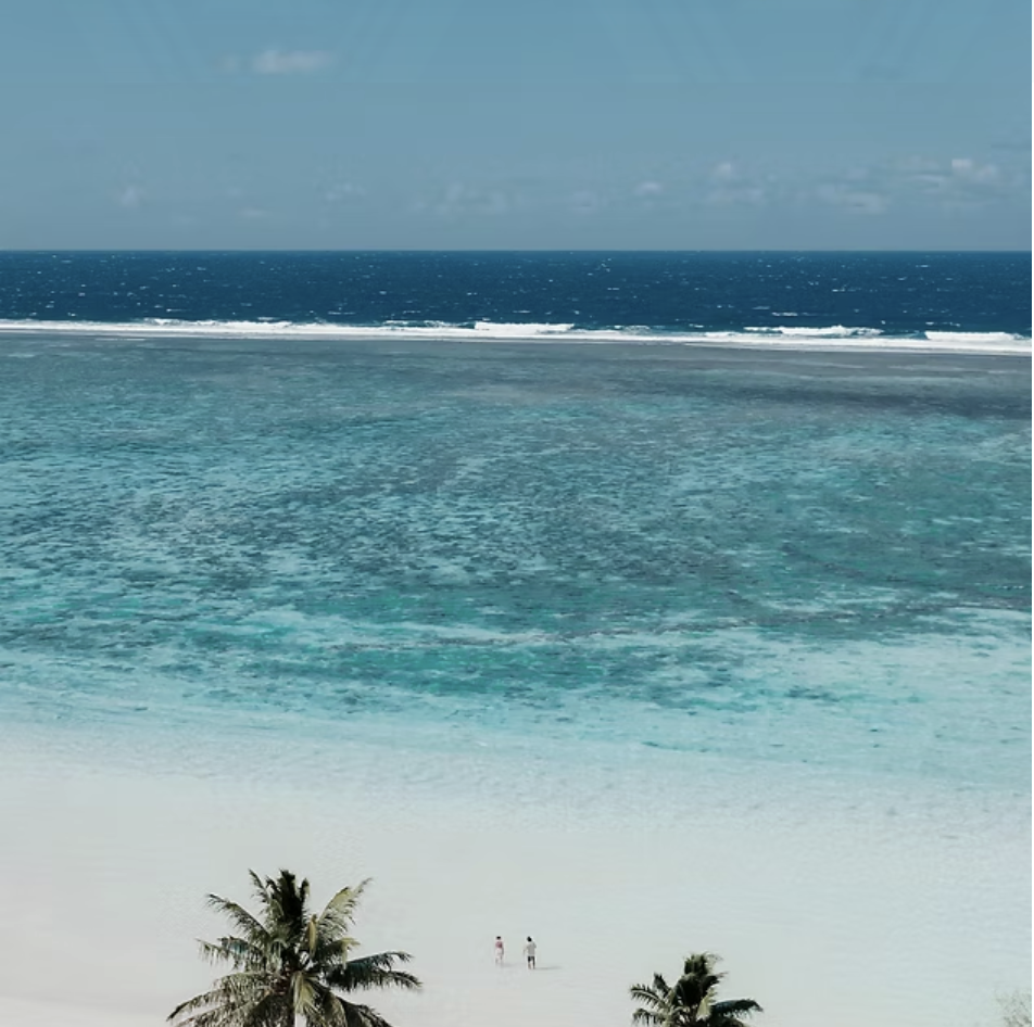 White sand beach looking out over the reef to the open ocean